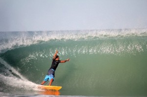 Another man surfing