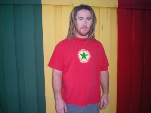 A longer-haired white man in a red T-shirt